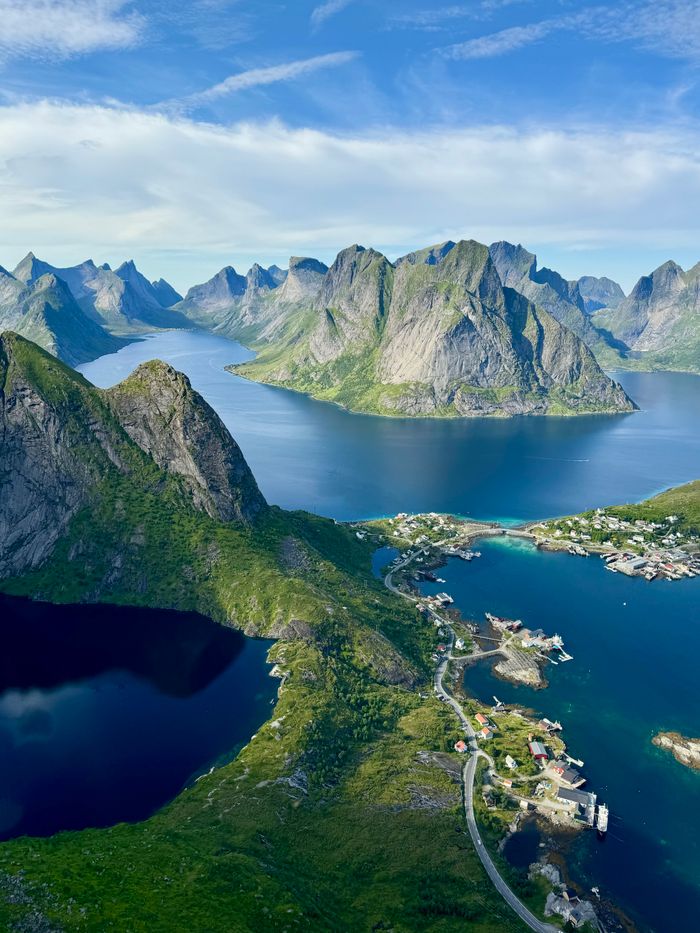 A breathtaking aerial shot of a fjord landscape with majestic mountains and water reflections.